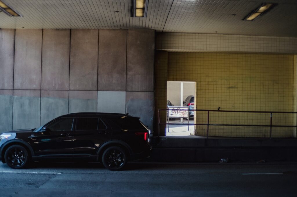 Black armored SUV in secure transport garage